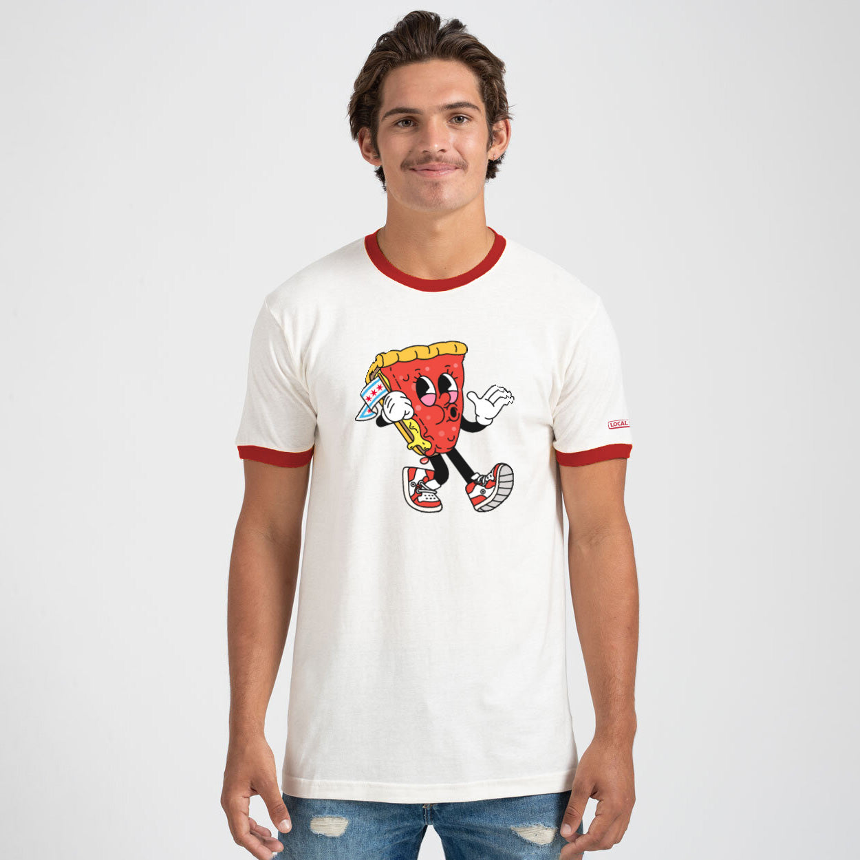 Person wearing a white t-shirt with a cartoon character design on a plain background