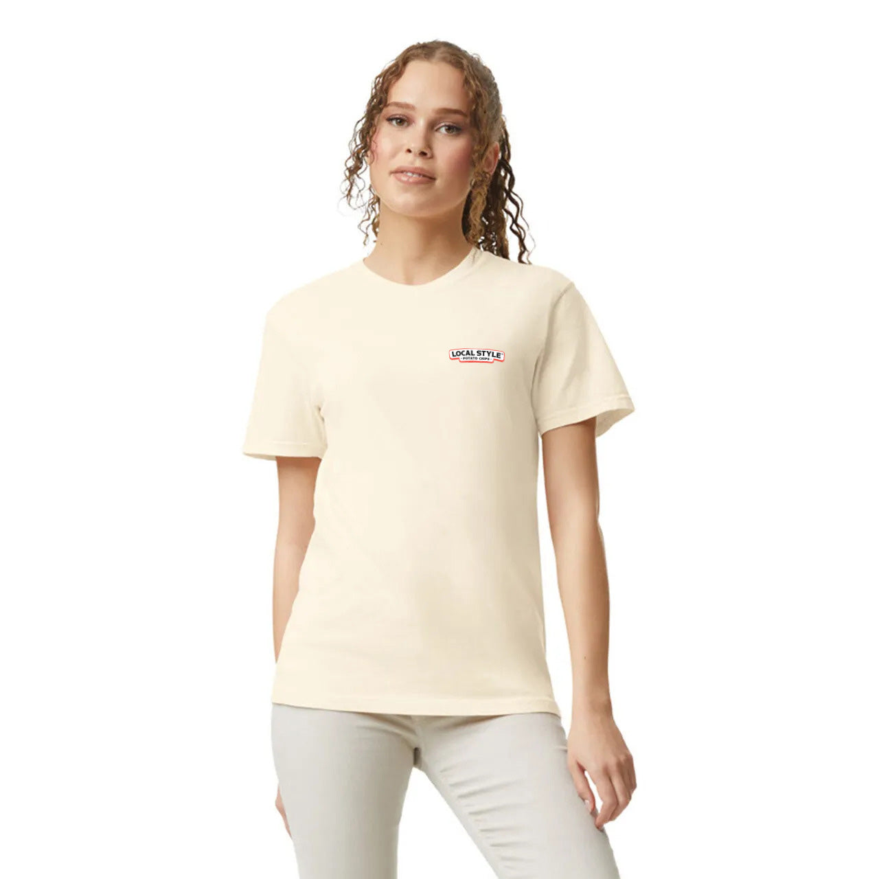 Woman wearing a light-colored t-shirt with a small logo on a white background