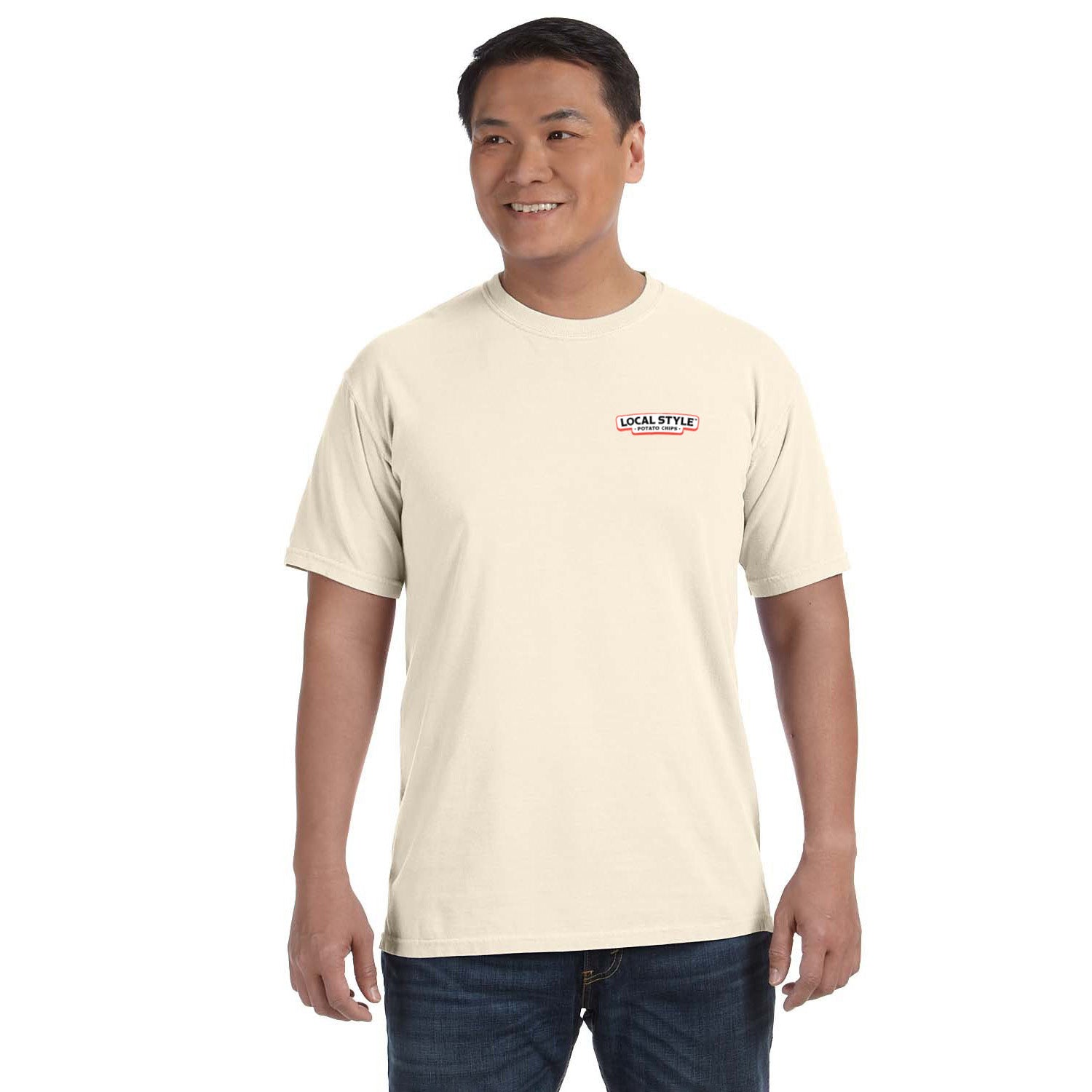 Man wearing a beige t-shirt with a logo on a white background