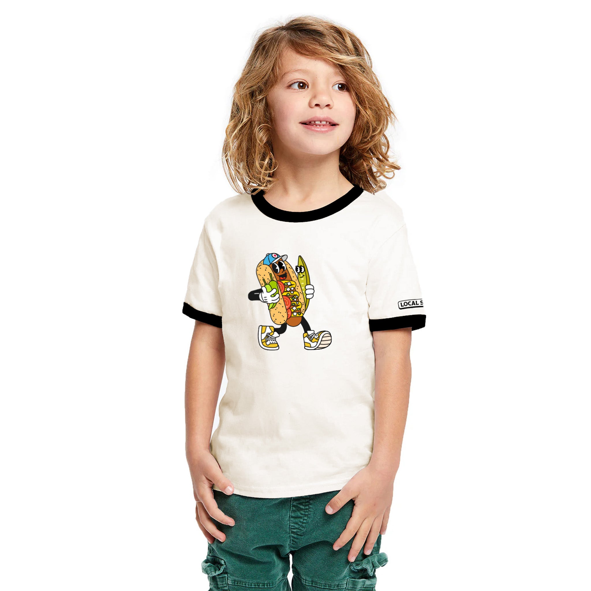 Child wearing a white t-shirt with a cartoon character design on a plain background